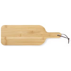 A bamboo cutting board with a rounded handle and a leather hanger, featuring a natural wood finish.