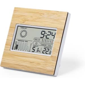 A weather station with a wooden finish displaying time, temperature, humidity, and weather forecast icons. It has a sleek design.