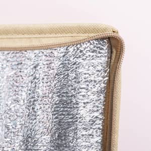 A cooler bag featuring a silver insulated lining and a tan exterior with a zip closure.