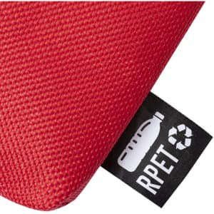 A red toiletry bag featuring a textured surface and a small tag indicating it's made from RPET material.
