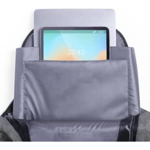 A grey backpack with a laptop and a tablet visible in the main compartment, featuring a logo.
