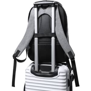 A black and grey backpack with padded straps mounted on top of a white suitcase. The backpack features a logo.