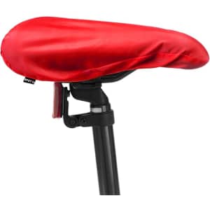 A red saddle cover with a smooth texture, designed to fit over a bicycle saddle. It features a logo on the side.