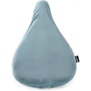 A teal saddle cover with a smooth finish, designed for bicycle seats, featuring a small branding tag.