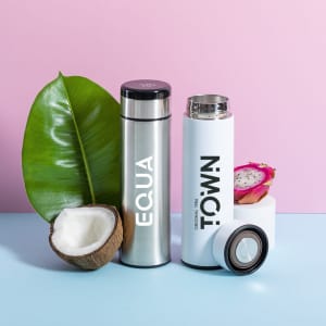 A drink bottle set includes a stainless steel vacuum flask and a white thermos, alongside tropical elements.