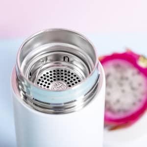 A drink bottle with a stainless steel interior and a mesh strainer, featuring a white exterior.