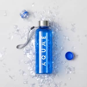A drink bottle in vibrant blue with a silver cap and a logo, surrounded by clear ice-like pieces.