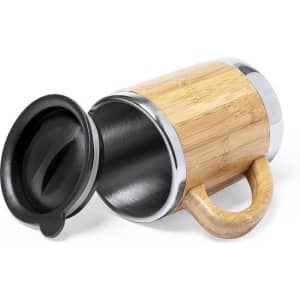 A travel mug with a bamboo exterior, stainless steel interior, and a black lid, featuring a sturdy handle.