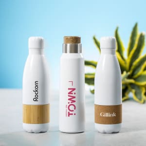 A drink bottle trio featuring white and bamboo designs, with one bottle showcasing a cork accent and a logo.