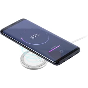 A wireless charger in a sleek design with a smartphone showing battery charging status. The charger has a minimalistic appearance.