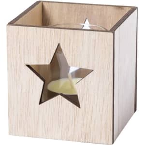 A wooden candle holder with a star cutout, featuring a candle inside. The holder is light-coloured with a sleek design.