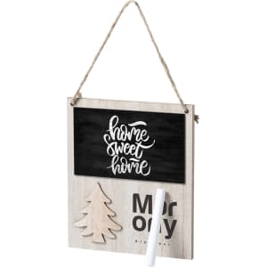 A wooden Christmas decoration featuring a chalkboard for messages, with a tree cutout and a rope hanger.