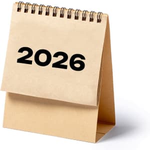 A desk calendar featuring a spiral binding, displaying the year 2026 on a simple beige background.
