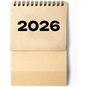 A desk calendar featuring a spiral binding, displaying the year 2026 in bold black numerals on a beige cover.