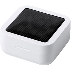 A compact white charging case featuring a black solar panel on the top.