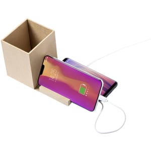 A brown multifunction pencil holder with two smartphones leaning against it, connected to a charging cable.