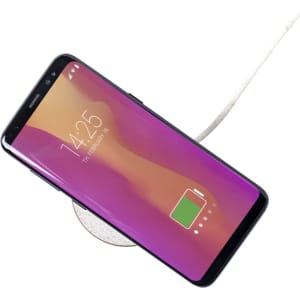 A wireless charger with a sleek design and a smartphone displaying a battery charging icon on its screen.