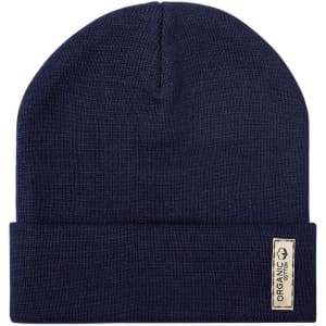 A navy beanie hat with a folded cuff and a small tag, featuring a logo. Made from organic cotton.