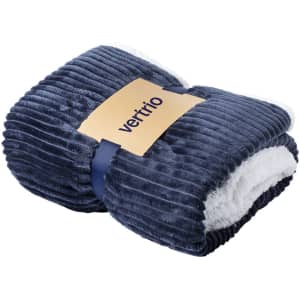 A navy blue ribbed blanket with a soft white interior, featuring a logo on the band.