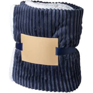 A plush navy Karovix blanket with a soft, textured exterior and a contrasting white interior, secured with a band.