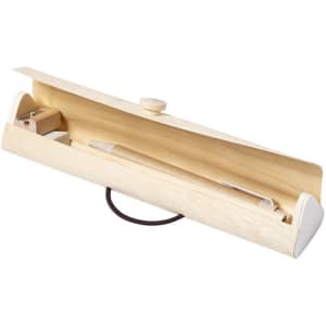 A wooden pencil case with a light finish, featuring a button closure and containing a pencil and sharpener inside.