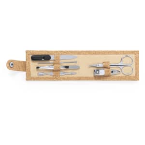 A manicure set with silver metal tools including scissors, nail clippers, and tweezers in a beige case.