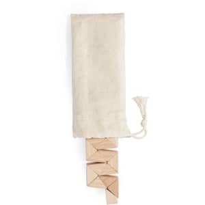 A set of wooden triangular blocks in a cotton bag. The blocks are a natural wood colour, with a light fabric cover.