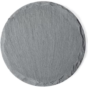 A round slate coaster in dark grey, featuring a textured surface and a rustic edge.