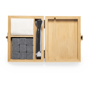Bamboo box containing grey stone ice cubes, a black scoop, and a white cloth for storage.