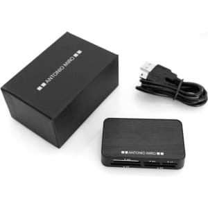 A black card reader with multiple slots, accompanied by a USB cable and a black box packaging.