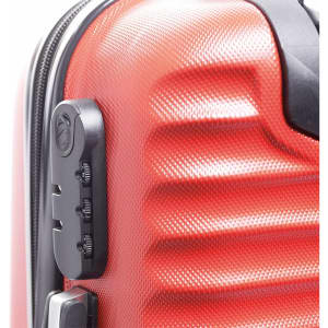A close-up of a red wheeled bag featuring a textured surface and a zipper with combination lock.