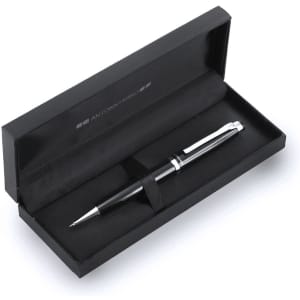 A sleek black metal pen laid inside an elegant black gift box with a fabric lining. The box features a logo.