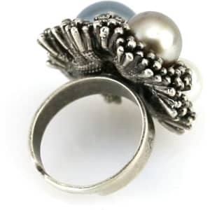 A silver adjustable ring featuring three decorative pearls in blue, white, and grey.