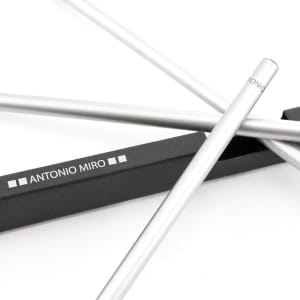 A silver pencil set displayed with a black box featuring a logo, showcasing a sleek design.