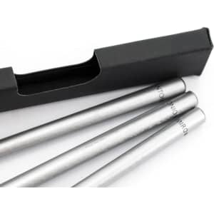 A grey-lead pencil set in a sleek black box, featuring three silver-coloured pencils with a branding logo.