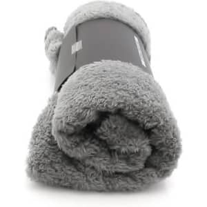 A rolled grey Kira Blanket wrapped in a black band, featuring a soft, plush texture.