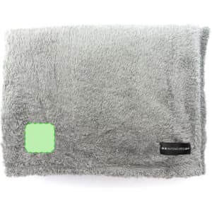 A fluffy grey blanket featuring a logo, perfect for adding comfort to any living space.