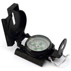 A black compass with a transparent cover, featuring a circular dial and measurement markings on the side.