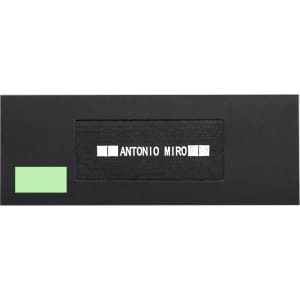 A sleek black box with a green detail and a logo design inside, featuring the name "Antonio Miro."