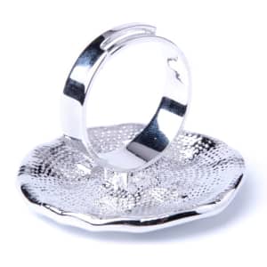 A silver Zook Adjustable Ring displayed on a textured silver dish. The ring features a sleek, modern design.
