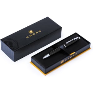 A metal pen in a black presentation box with a brand logo. The pen features a sleek black design with silver accents.