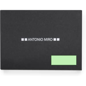 A black promotional product with a logo and a green label design.