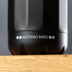 A drink bottle in sleek black with a glossy finish, featuring a logo on the side.