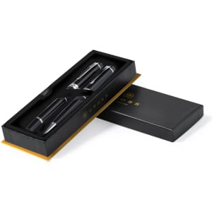 A metal pen set in a black and gold box, featuring two pens with a sleek design. The box has a logo.
