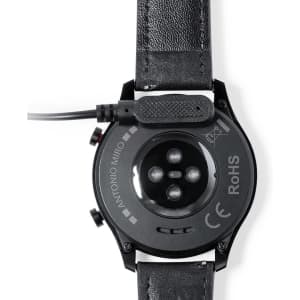 A black smartwatch with a leather strap, featuring a charging port and sensor on the back.