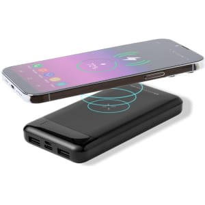A black power bank with multiple charging ports, featuring a smartphone on top showcasing a wireless charging icon.