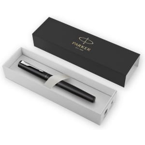 A black metal pen presented in a white box with a black outer sleeve, featuring a logo on the lid.