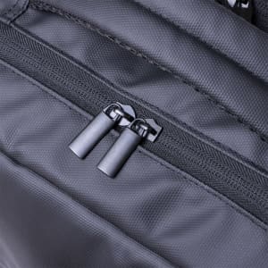 A black backpack featuring dual zippers, showcasing a close-up of its textured fabric and hardware.