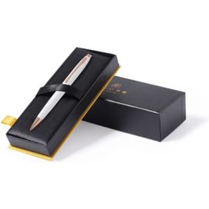 A metal pen in white and rose gold, presented in a black gift box with a yellow interior.