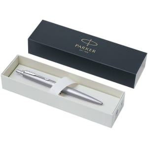 A silver metal pen displayed in a cream and dark blue box with a logo.